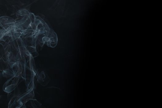 Abstract Smoke swirls on black background