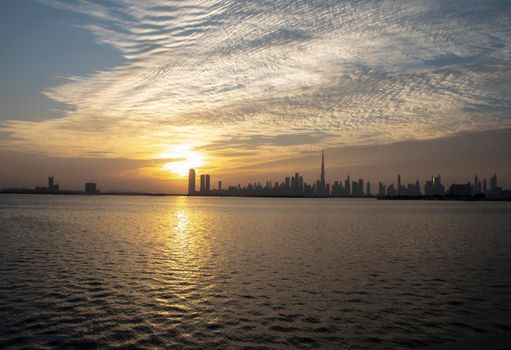 Dramatic sunset over a Dubai city. UAE.