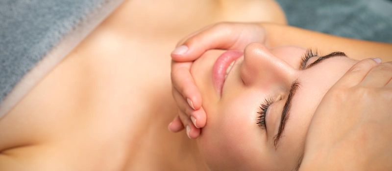 Face massage of detox therapy for the pretty female patient at spa salon