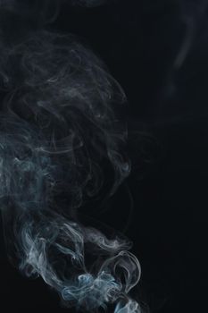 Abstract Smoke swirls on black background