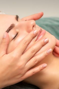 Face massage of detox therapy for the pretty female patient at spa salon