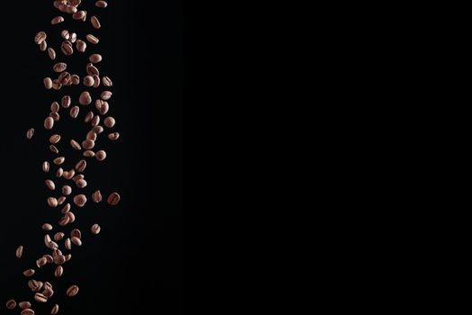 Fresh ccoffee beans in flight on a dark background