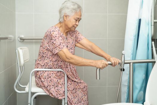 Asian senior or elderly old lady woman patient use toilet bathroom handle security in nursing hospital ward, healthy strong medical concept.