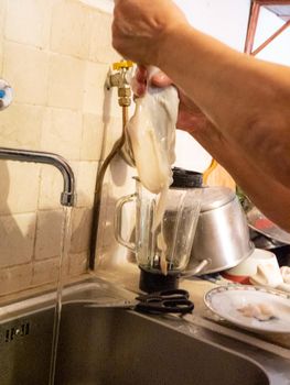 cleaning a raw adriatic cuttlefish at home in Numana, Marche, Italy