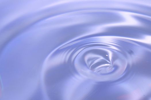 Beautiful blue background in the form of circles on the water. Universal abstract blurred background.