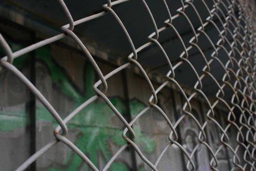 Rusty metal mesh close-up on the background of painted walls.