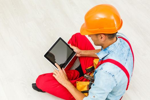 Construction worker holding digital tablet, repair, construction concept.