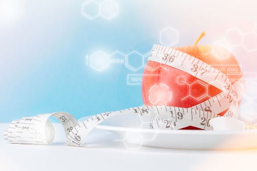 Apple as a means for weight loss. Obesity problem. Fruit diet. Apple and measuring tape.