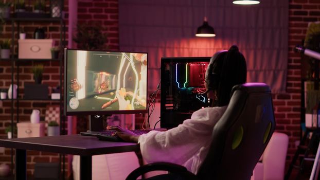 African american woman streaming first person shooter competition upset after losing online tournament on gaming pc at home. Gamer girl playing online action game unhappy after failing level.