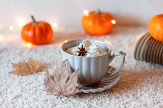 cosy autumn composition with hot drink and mini pumpkins, side view, selective focus