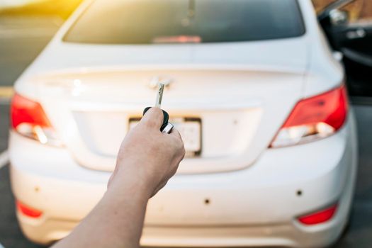 Driver hands showing the car keys. Driver hands showing the keys outside the vehicle, Vehicle rental concept. Close-up of driver outside car holding keys