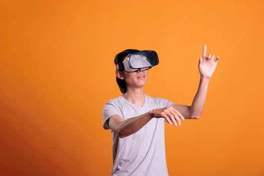 Man wearing vr headset playing virtual reality games in cyber space, exploring metaverse. Person in ar head device enjoying simulation experience, cyberspace entertainment, modern lifestyle