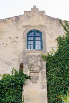 Ancient, entwined with greenery Forte de Sao Clemente in Vila Nova de Milfontes on the Sunset