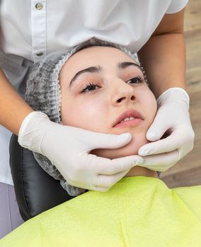 Dentist looks at a jaw of female patient. Showing the bite to the doctor