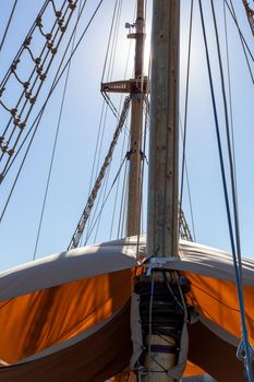 schooner mast with sails over the blue sky background