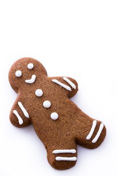 Homemade gingerbread cookies decorated with white icing on white background.