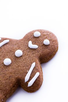 Homemade gingerbread cookies decorated with white icing on white background.