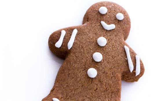 Homemade gingerbread cookies decorated with white icing on white background.