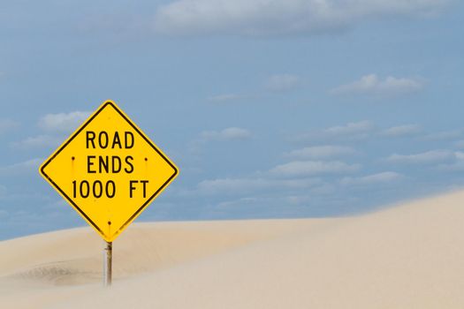 Yellow road sign at the end of the road.