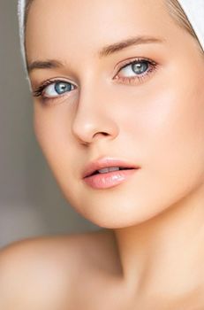 Skin care and beauty routine, beautiful woman with white towel wrapped around head, skincare cosmetics and face cosmetology, close-up portrait