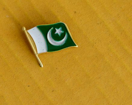 Pakistan flag gold metal badge with selective focus