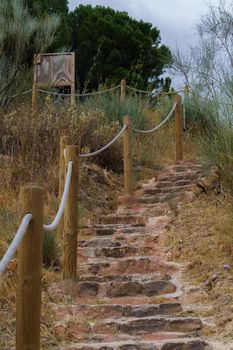 stairs leading to the cave of the hundidero in montejaque, malaga, spain with wooden posts and rope to hold on.
