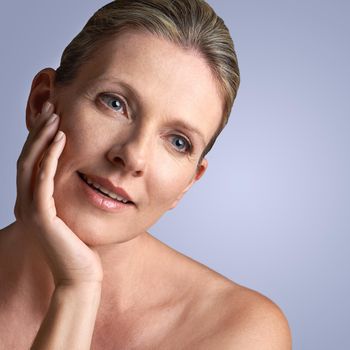 Beauty is about being comfortable in your own skin. Cropped studio shot of a beautiful mature woman touching her face