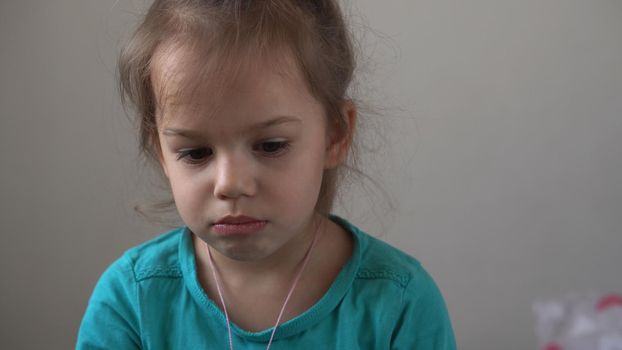 Portrait little girl sad upset child burst into tears cries sob looking at camera indoors. sincere children emotions feelings at home crying kid with pretty face. Concept childhood insult offend grief.