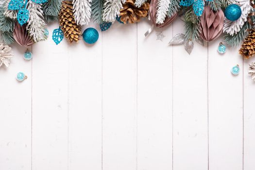 Christmas flat lay composition from pine, cones, balls on wooden background top view. Copy space.