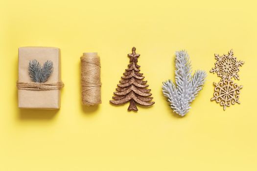 Festive minimal creative christmas composition with gifts and decorations flat lay on colored background.