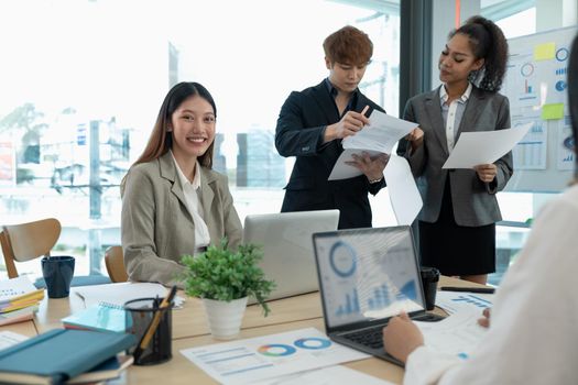 Diverse business people partners group negotiating at boardroom meeting. Multiethnic executive team discussing financial partnership agreement project strategy brainstorming sitting at table in office