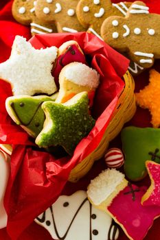 Assorted christmas cookies on red background.