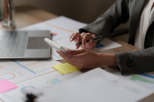 Asian Business woman working to analyze technical price graph and indicator. finance concept.