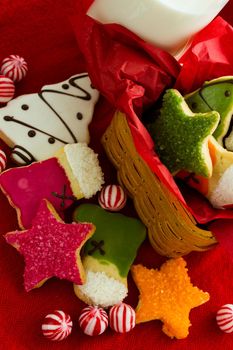 Assorted christmas cookies on red background.