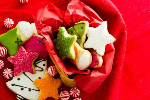 Assorted christmas cookies on red background.