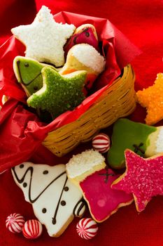 Assorted christmas cookies on red background.