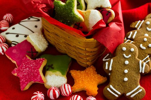 Assorted christmas cookies on red background.