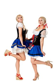 A full length portrait of two beautiful women in a traditional costume isolated on white. Oktoberfest. Beer Festival