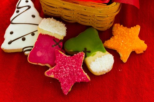 Assorted christmas cookies on red background.