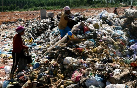 teixeira de freitas, bahia / brazil - may 6, 2008: People are seen reviving the garbage in search of material for recycling in the landfill of the city of Teixeira de Freitas.