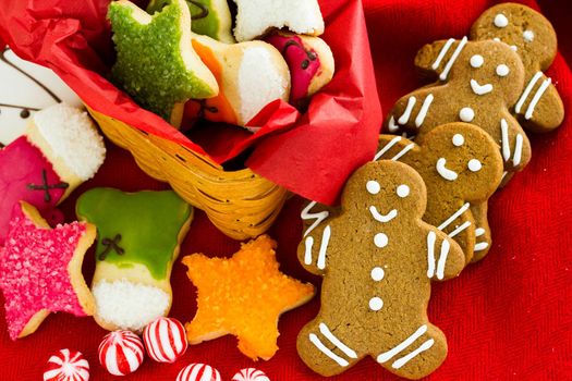 Assorted christmas cookies on red background.