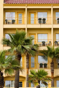 Yellow hotel with balconies.