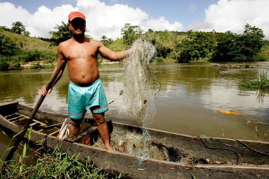 eunapolis, bahia / brazil - july 8, 2009: fisherman is seen in the waters of the Buranhem river in the city of Eunapolis, in southern Bahia.

