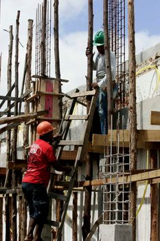 eunapolis, bahia / brazil - august 25, 2009: Construction workers are seen on construction site in the city of Eunapolis.
