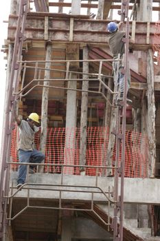 eunapolis, bahia, brazil - august 25, 2009: Construction workers working on construction of a building in the city of Eunapolis.