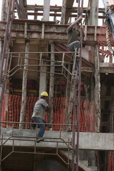 eunapolis, bahia / brazil - august 25, 2009: Construction workers are seen on construction site in the city of Eunapolis.
