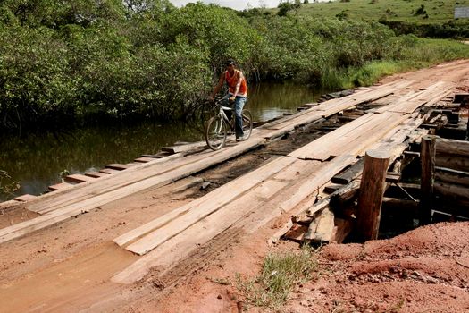 prado, bahia / brazil - july 7, 2009: vehicle is seen crossing wooden bridge over a dirt road in the rural area of the city of Prado, in southern Bahia.





