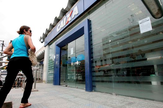 eunapolis, bahia / brazil - november 11, 2009: Customers are seen at the entrance of Banco Caixa Econômica Federal branch in the city of Eunapolis.