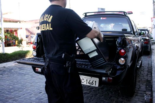 porto seguro, bahia / brazil - august 6, 2009: Federal Police agents are seen during an investigation operation in the city of Porto Seguro, in the south of Bahia.