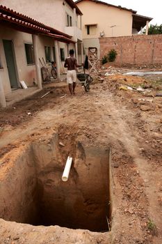 eunapolis, bahia, brazil - february 3, 2010: worker digging a hole for construction of a septic tank of a residence in the city of Eunapolis.
